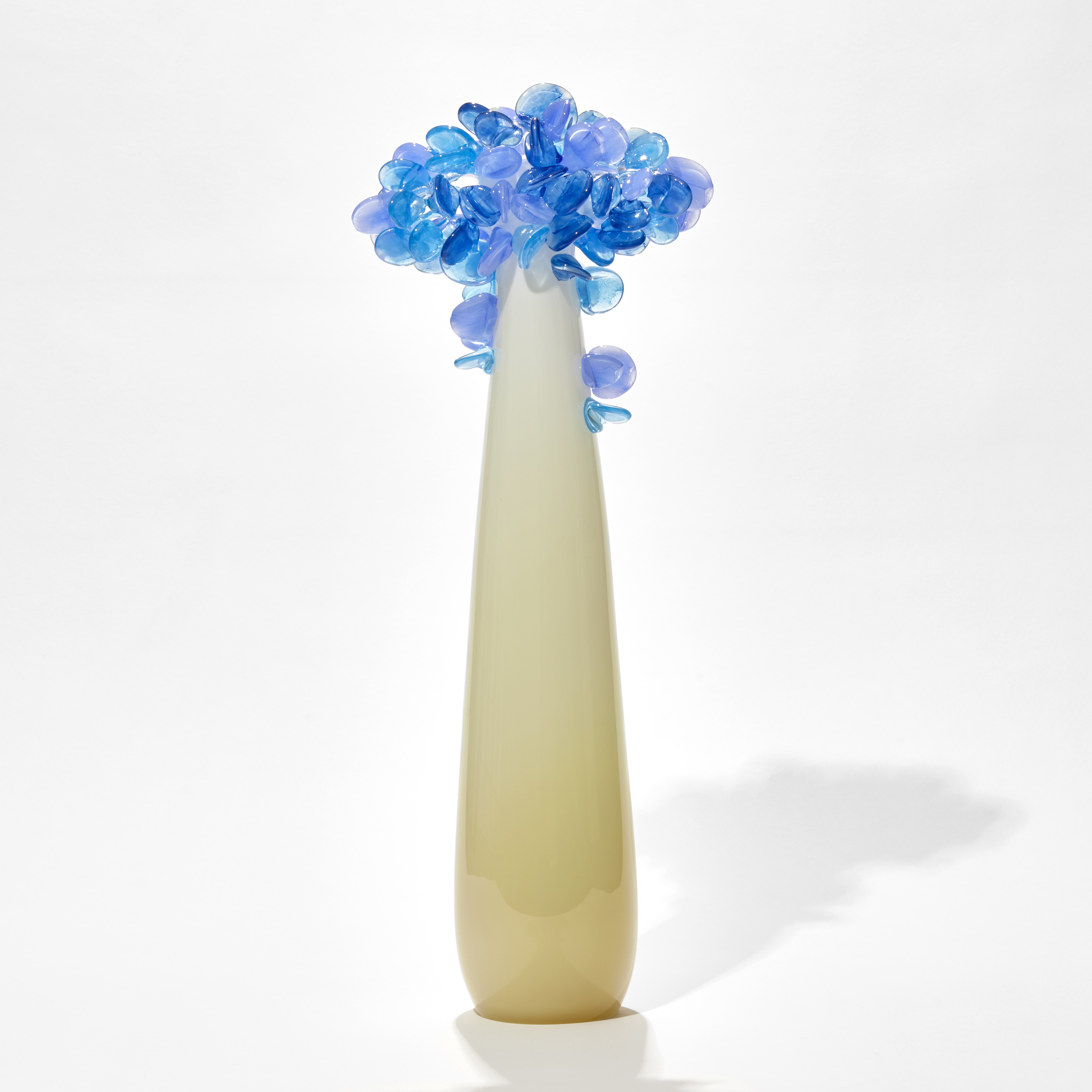 tall pop art hand made glass tree with alabaster coloured smooth trunk and candy coloured blue rounded mass of leaves on top