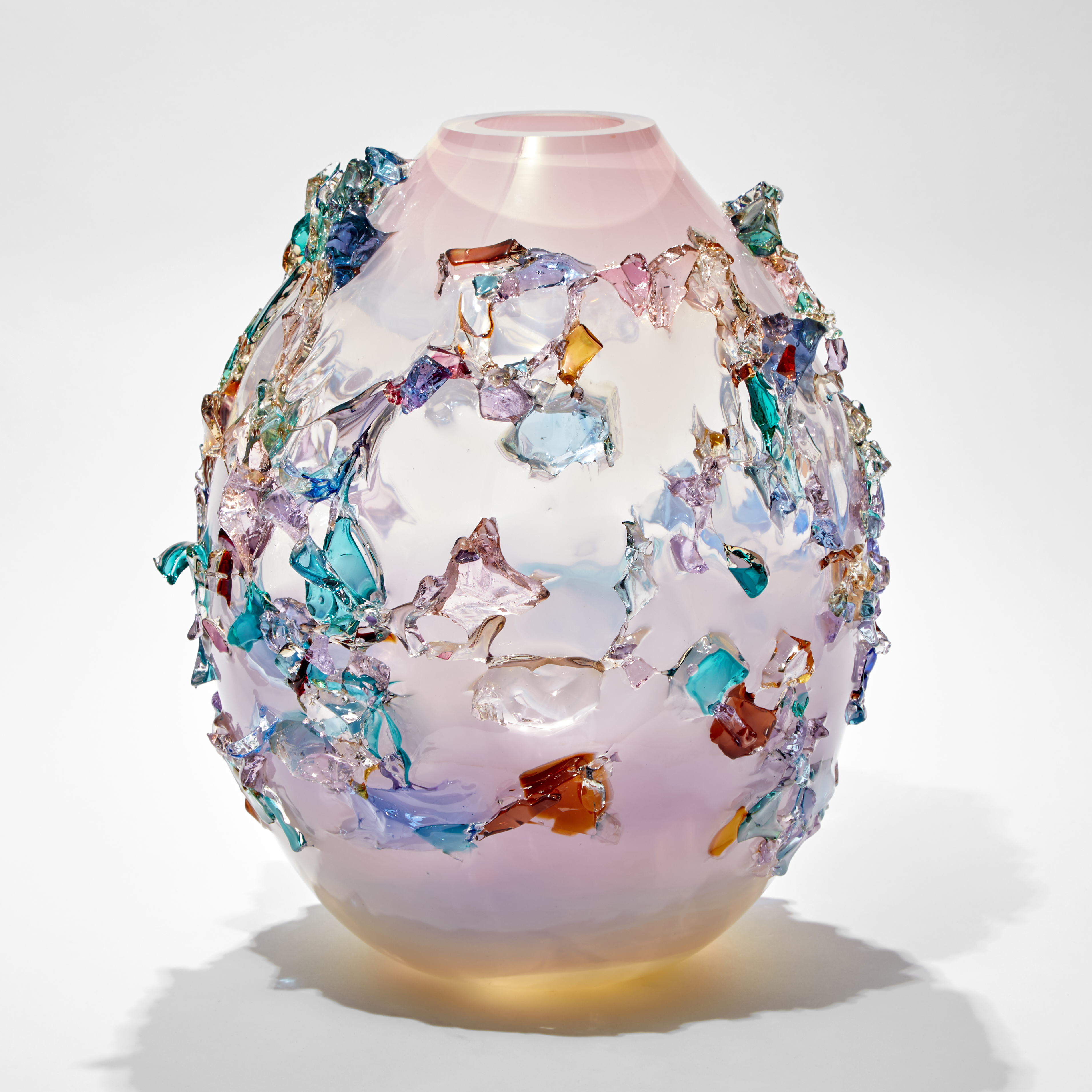 round oval pastel coloured glass vase covered in organic shards of glass in blue pink purple and jade hues