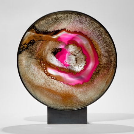 rounded 2d sculpture in metal frame and base made from shattered glass with trapped colours in gold black and bridge pink hand made