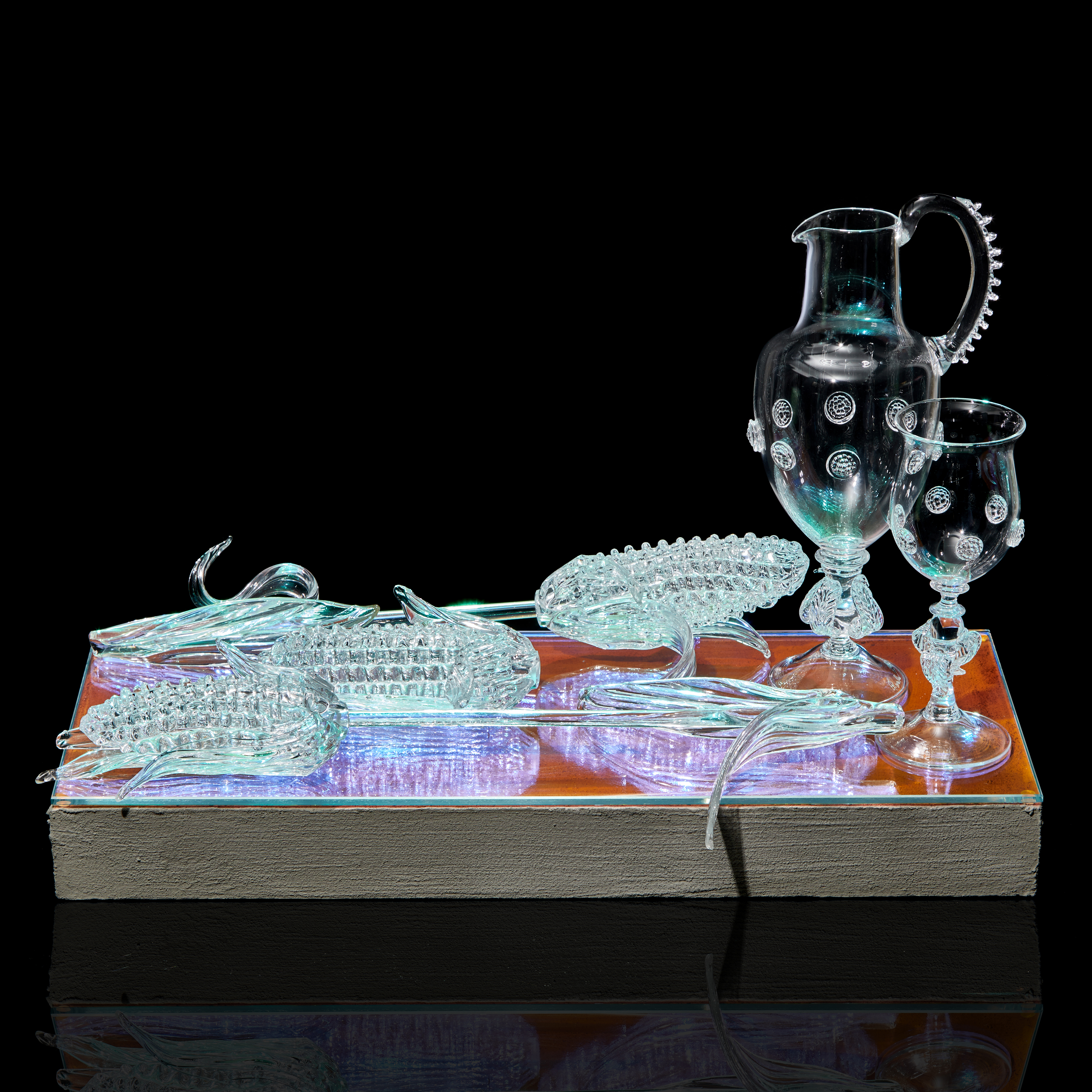 three dimensional still life setting with pitcher goblet corn heads hand made from glass