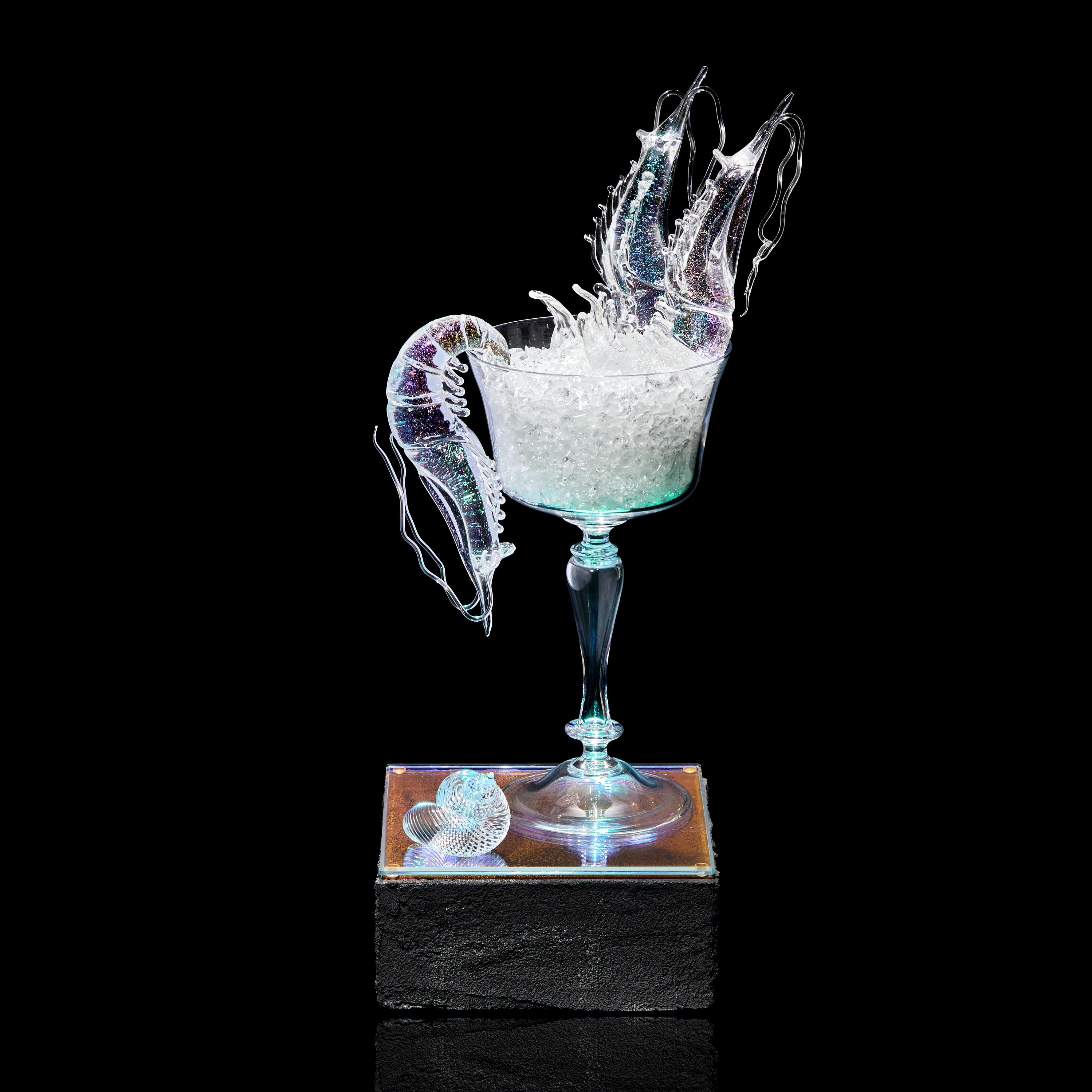 fancy goblet with crushed ice and two prawns with plinth below with prone prawn and sea shell hand made from clear glass