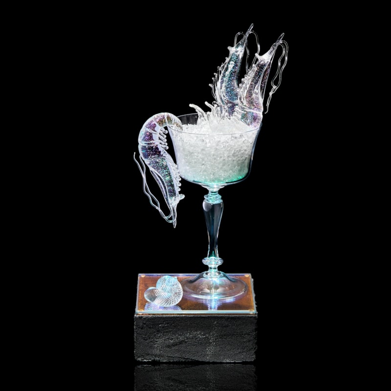 fancy goblet with crushed ice and two prawns with plinth below with prone prawn and sea shell hand made from clear glass