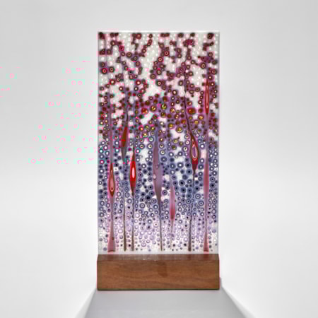 tall rectangular panel with organic detail that is a multitude of small dots and grass head shapes in blue purple white and red hand made from glass with wood base