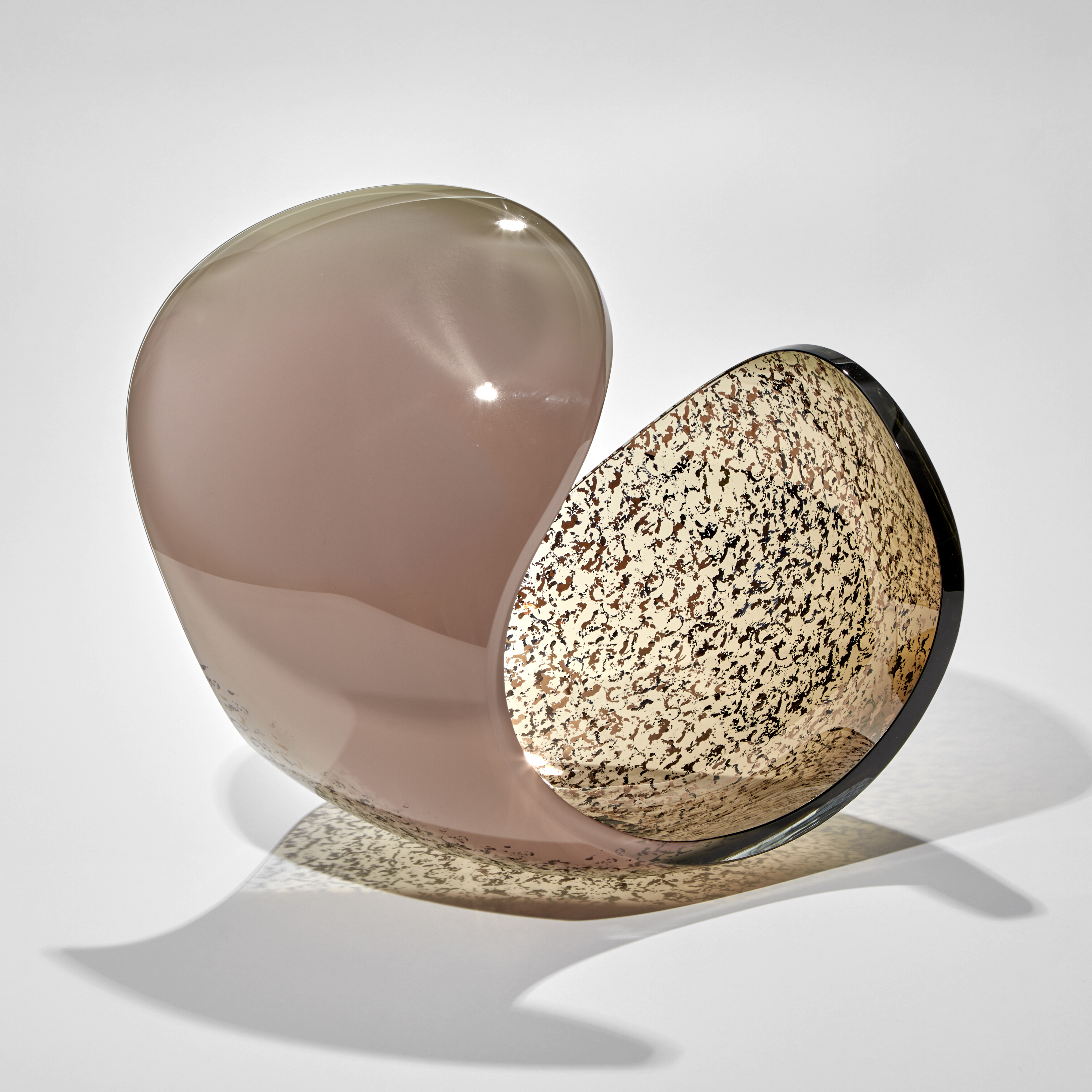 rounded form with dramatic curved edge and dropped side in ducky pink and bronze with gold speckled detail handmade from glass