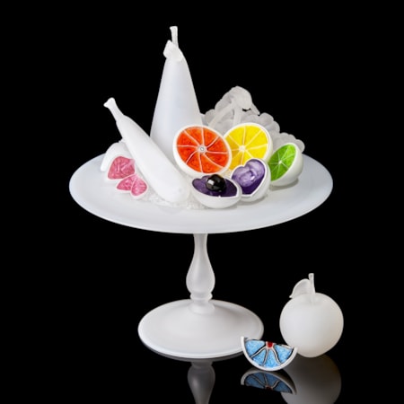 white centrepiece with bisected white fruits each with a different coloured interior handmade from glass