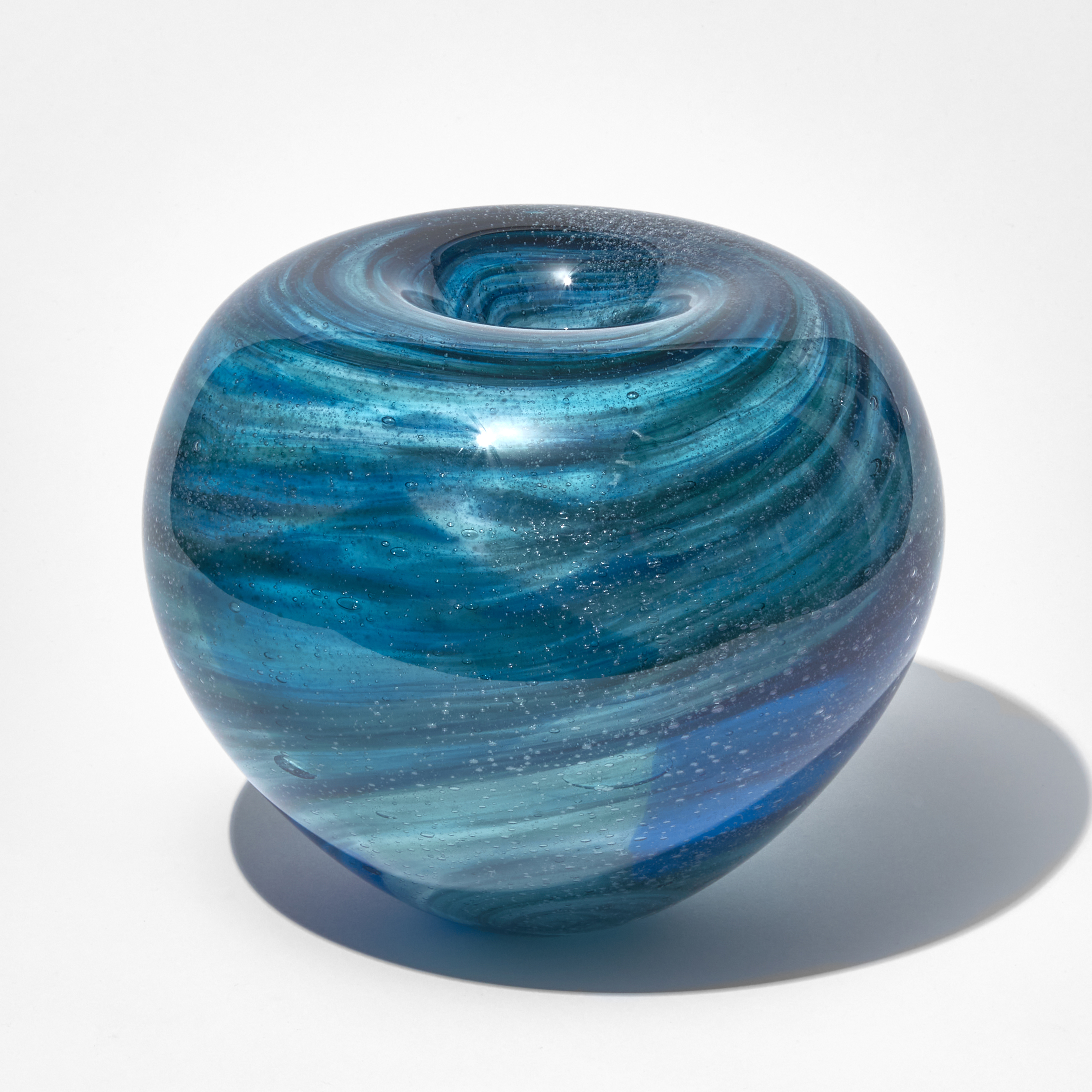 blue and black sculpted glass vessel with ringed swirl pattern