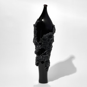 glass artwork of grey cloak on black model