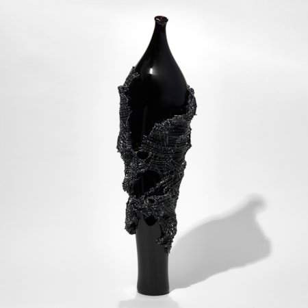 glass artwork of grey cloak on black model