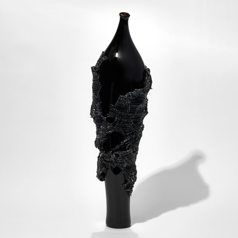 glass artwork of grey cloak on black model