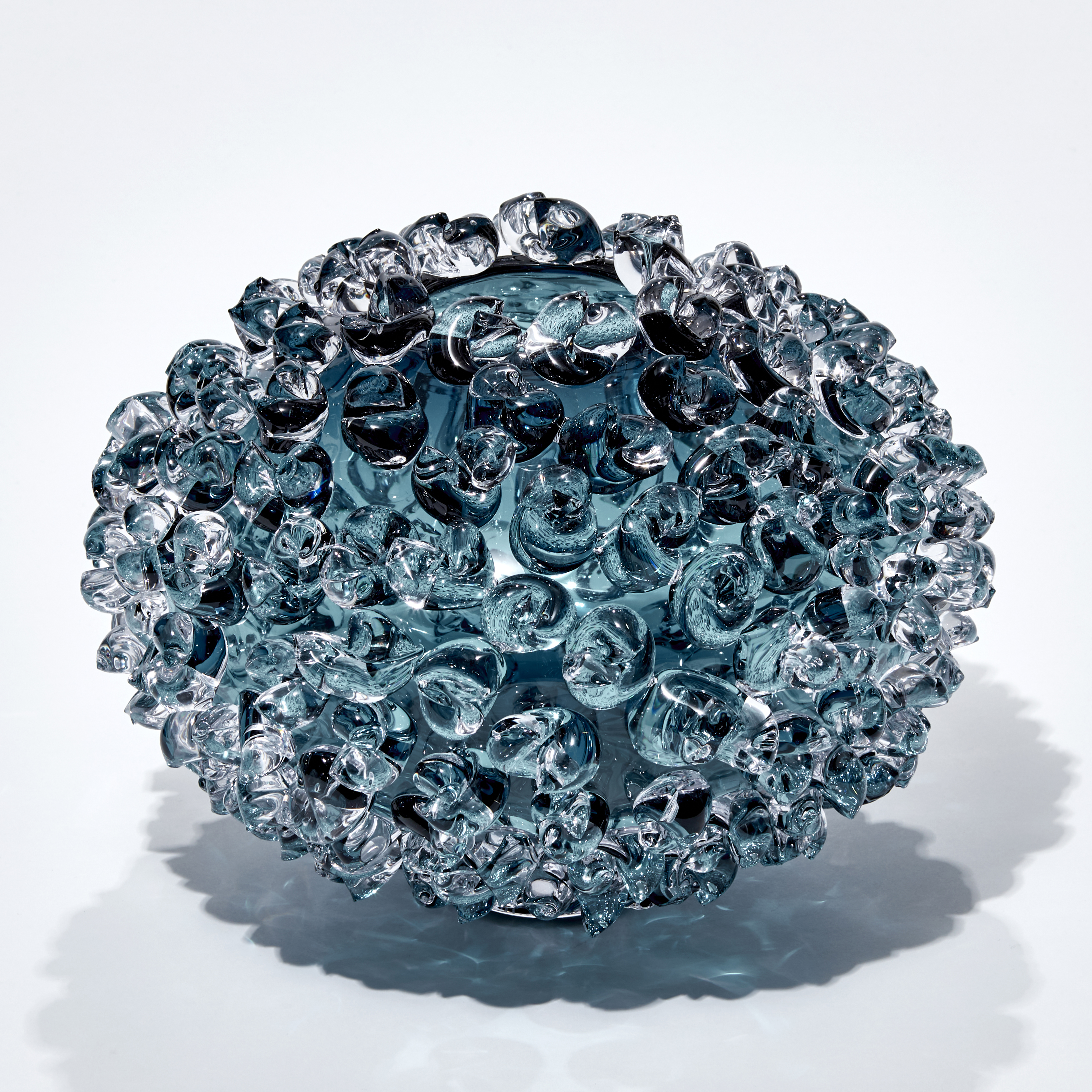 squashed round steel blue vase with protruding organic twisted adornment handmade from glass 