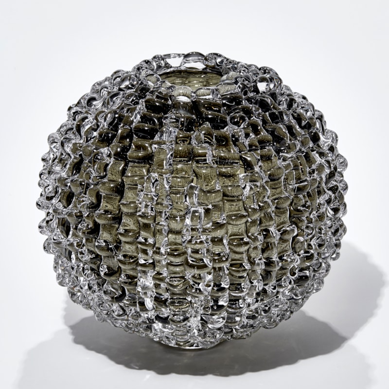urchin inspired round handmade glass sculpture in bronze grey colour with undulating ridged surface
