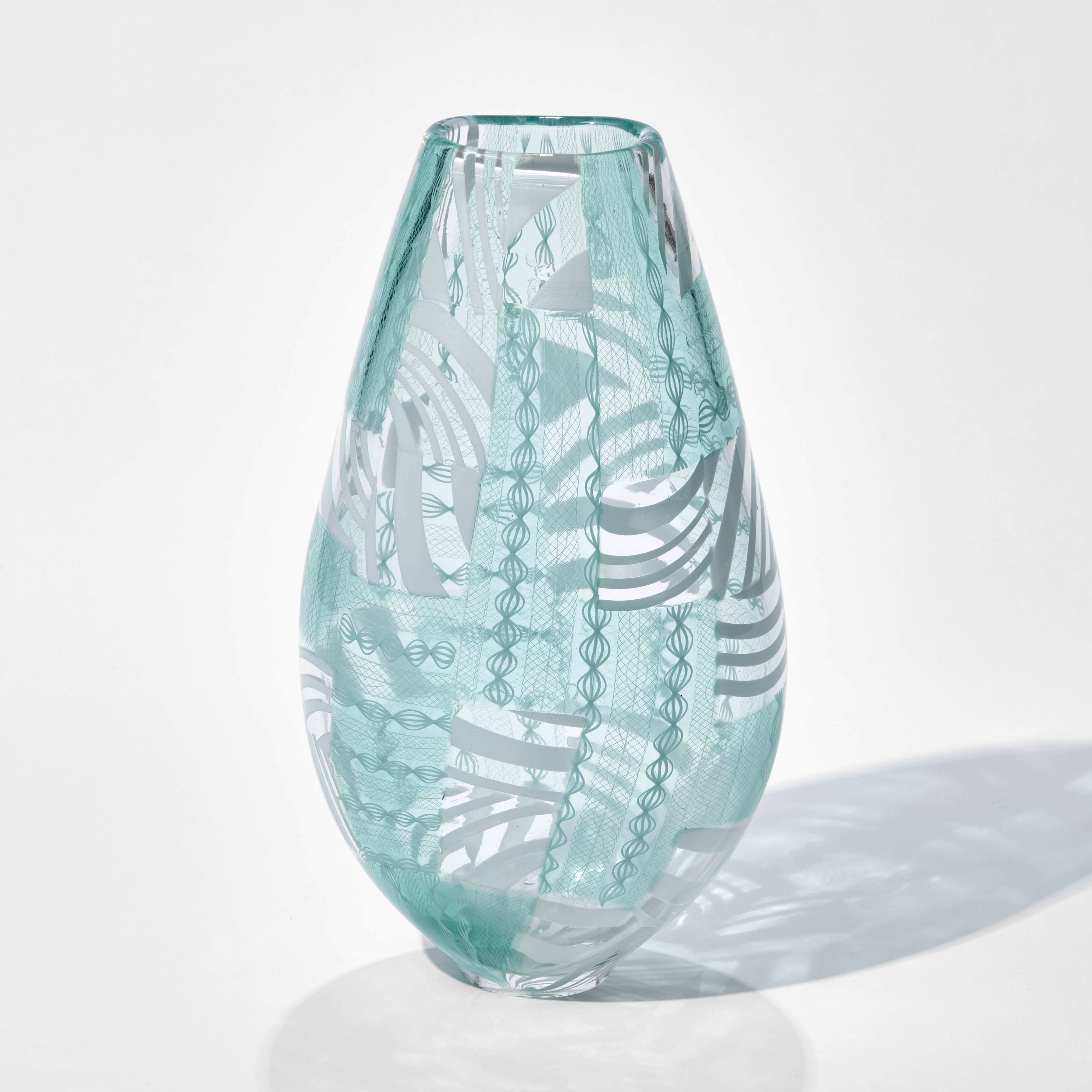 art glass vase in turquoise and white with modern line patterns