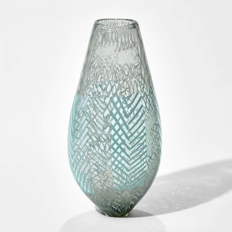 art glass vase in light green and grey with various external lined patterns