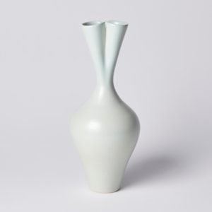 tall green ceramic sculpture of seed pod with twin necked top