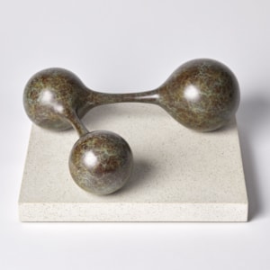 bronze minimalist sculpture of connected spheres on limestone base