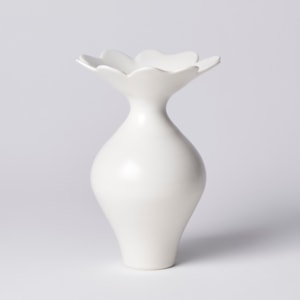 white rounded vase with wide raised scalloped shaped floral rim hand made from porcelain