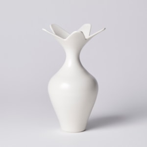 white classically shaped vase with wide five pointed star shaped opening hand made from porcelain
