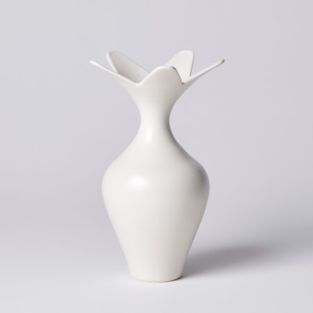white classically shaped vase with wide five pointed star shaped opening hand made from porcelain