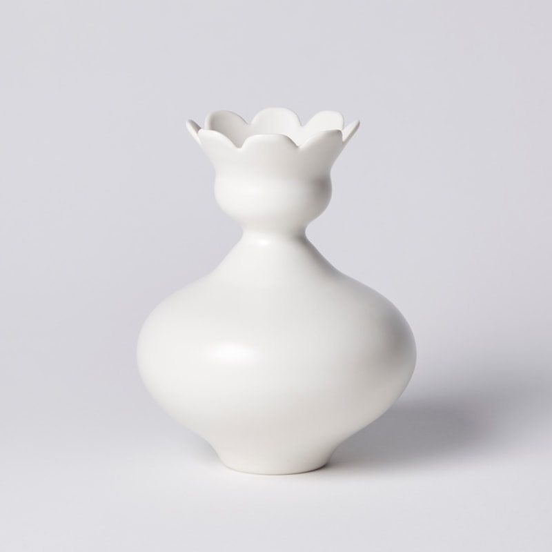 white squat rounded vase with flower shaped opening with eight petals hand made from porcelain