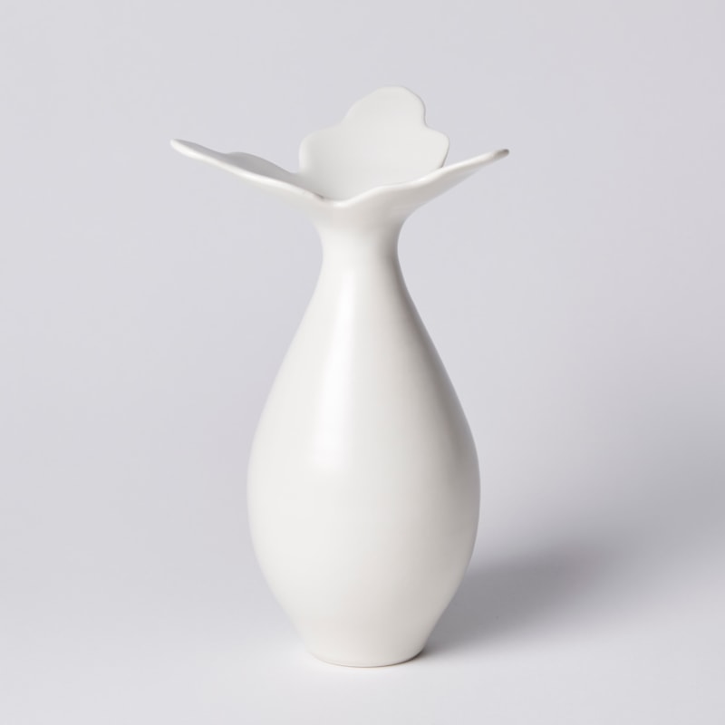 teardrop shaped white vase with wide opening made up from three extending flat pointed petals hand made from porcelain