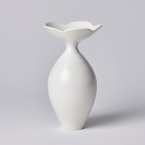 round oval shaped vase with wide flower shaped opening consisting of five flat petals hand made from porcelain