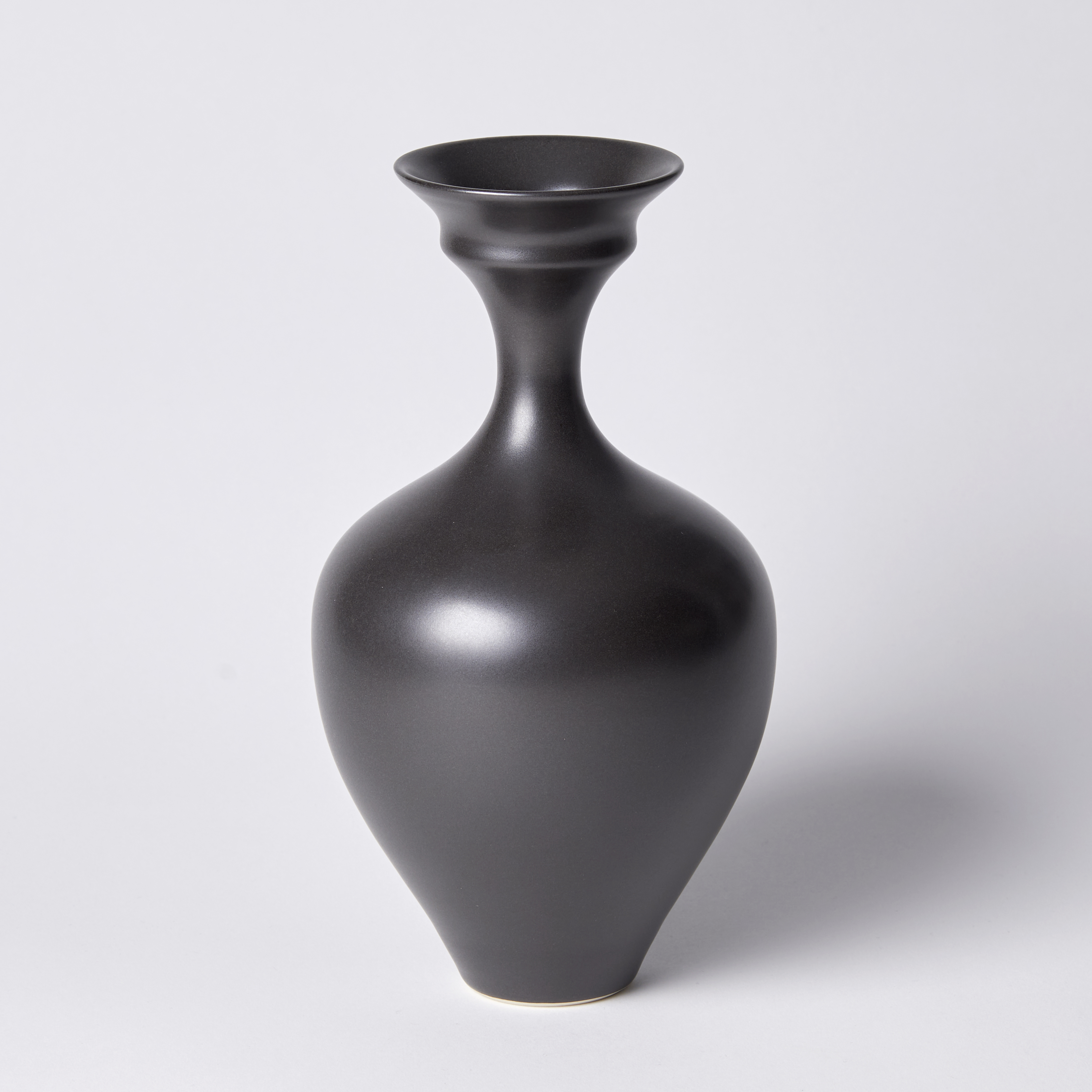 black classical vase with sweeping cursed narrow neck and flaring double rimmed lip hand made from porcelain