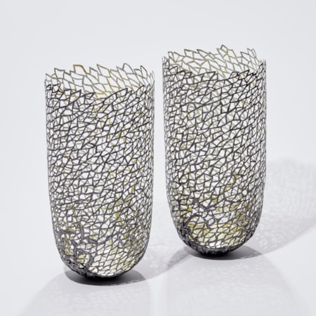 two modern art sculpted vessels made from steel and gold