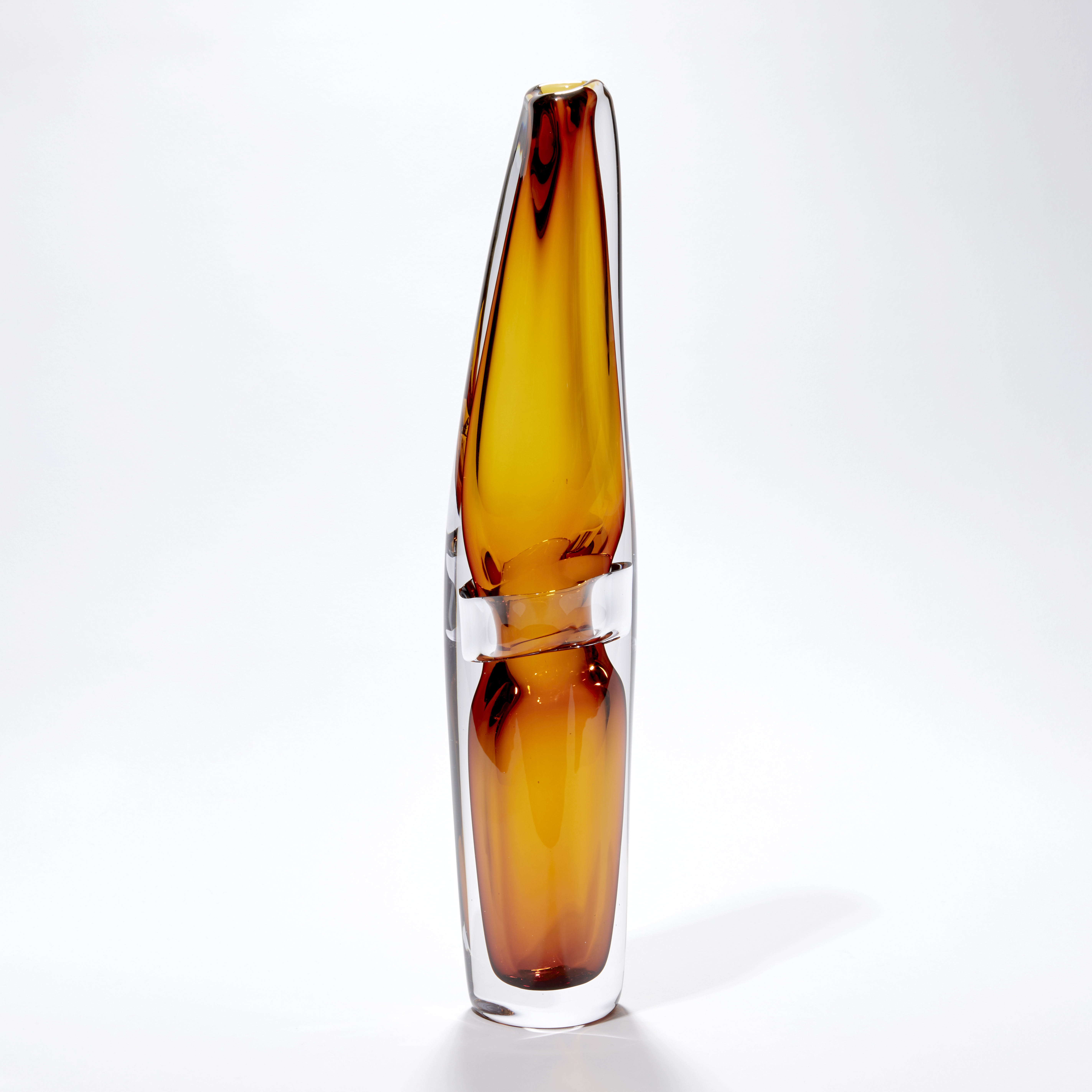 clear and transparent amber tall vase with fluid lines and soft narrowing top handblown from glass