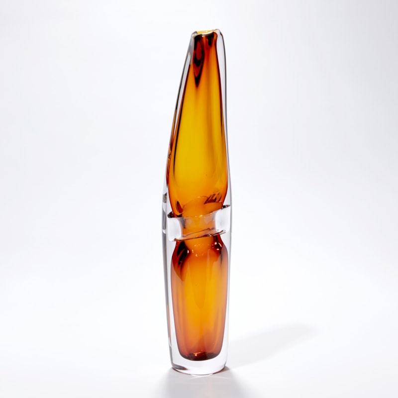 clear and transparent amber tall vase with fluid lines and soft narrowing top handblown from glass