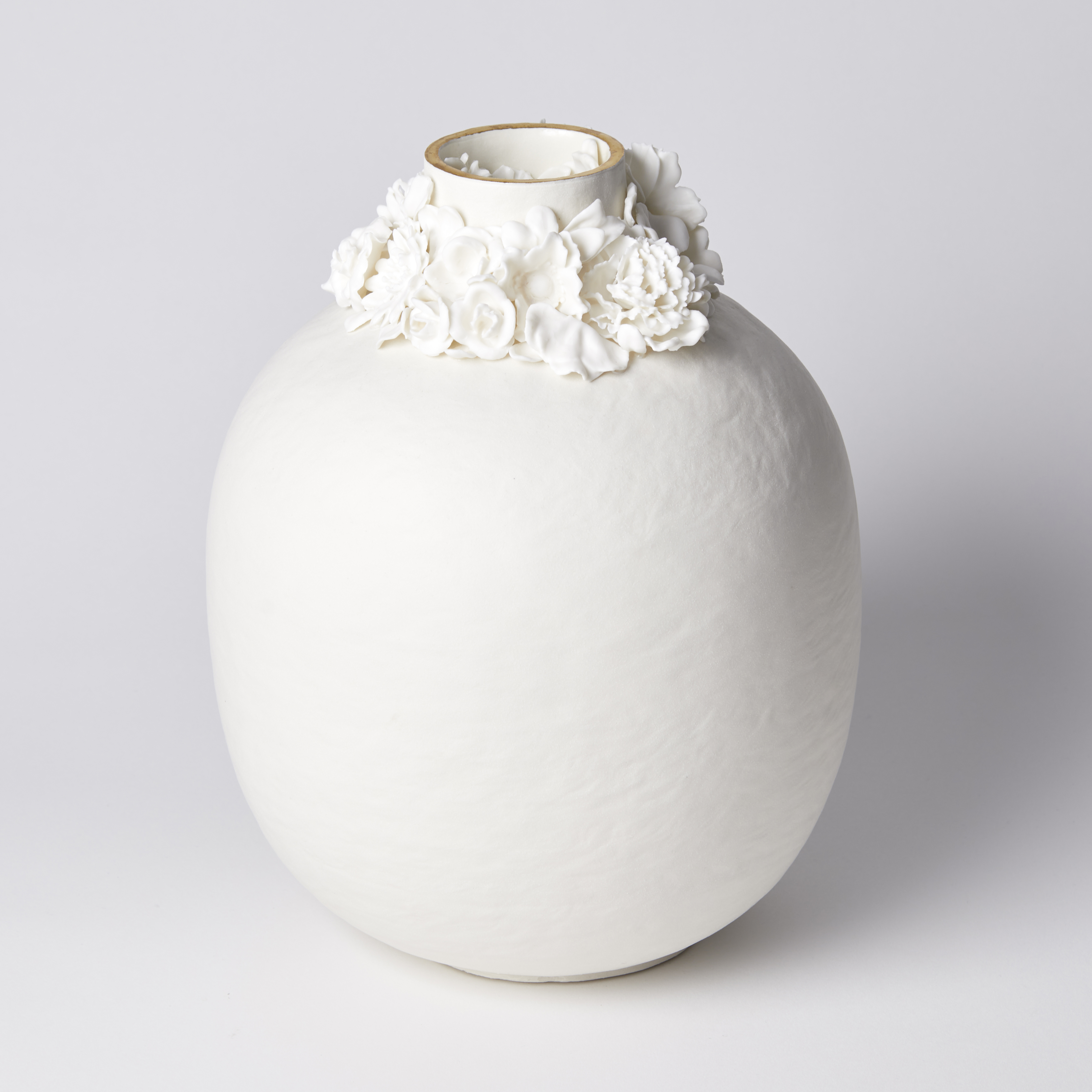 rounded jar with slightly uneven surface and floral ring around the opening with gold lustre band hand made from porcelain and parian