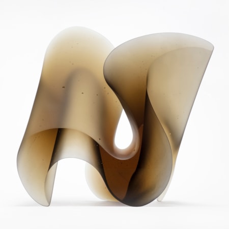bronze brown perched standing curling cast glass sculpture with two flat polished sides and curving matt planes