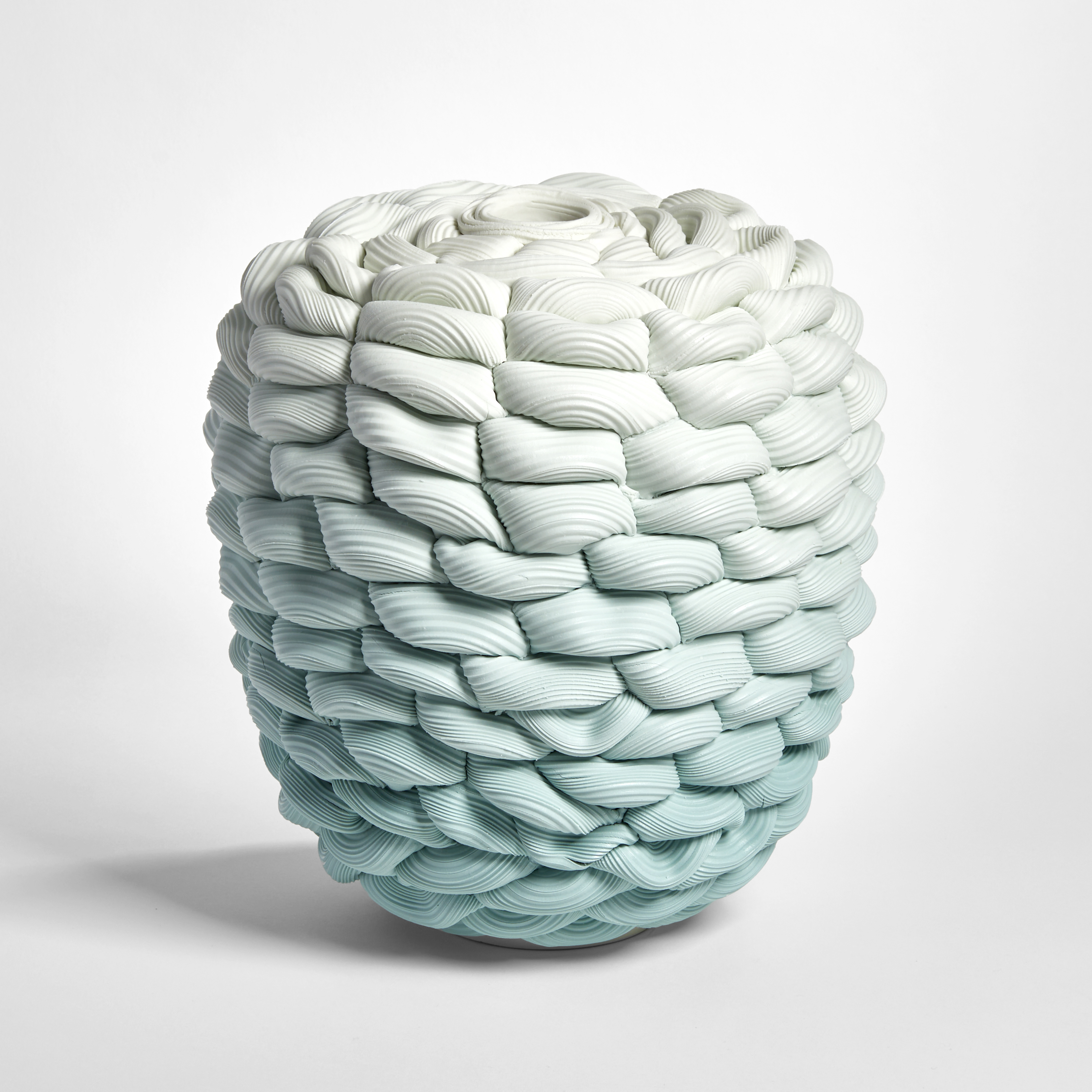 teal aqua fading to off white chunky woven and ridged vessel in a flat topped barrel shape hand made from parian porcelain