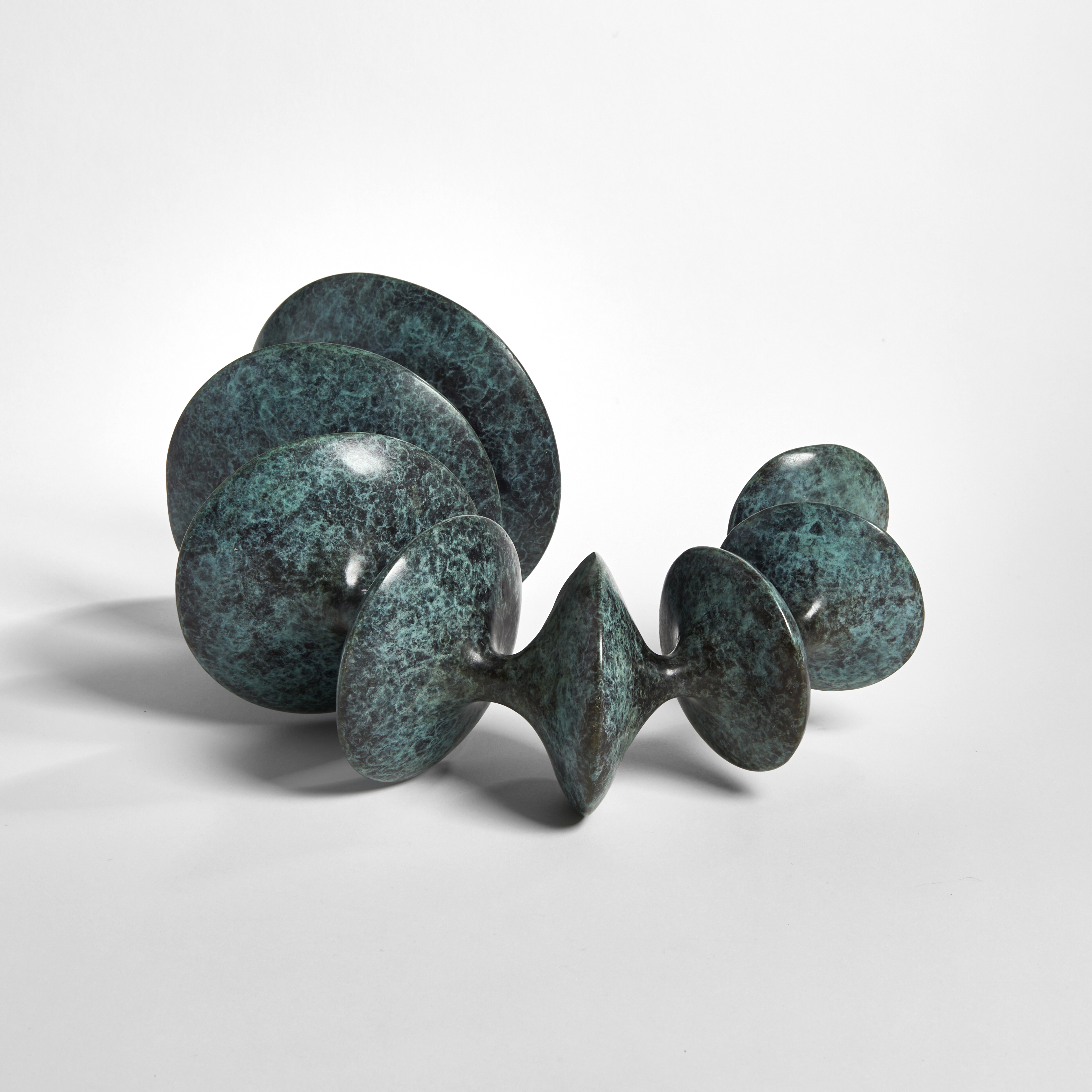 sculpted bronze artwork of circular forms linked by thread