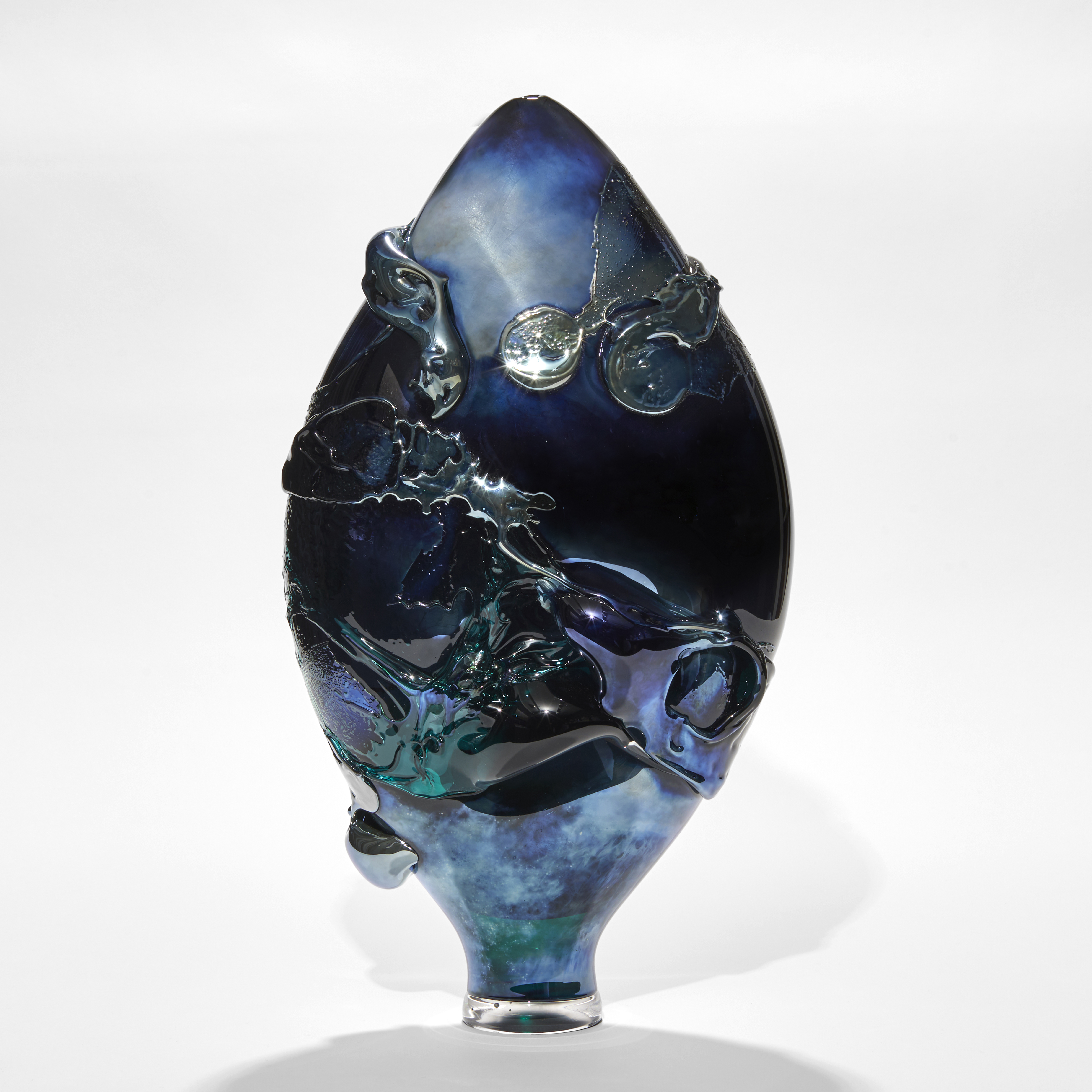 dark intense metallic blue teardrop shaped vase with organic trailing and swirling raised texture hand made from glass