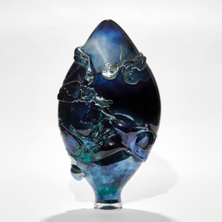 dark intense metallic blue teardrop shaped vase with organic trailing and swirling raised texture hand made from glass