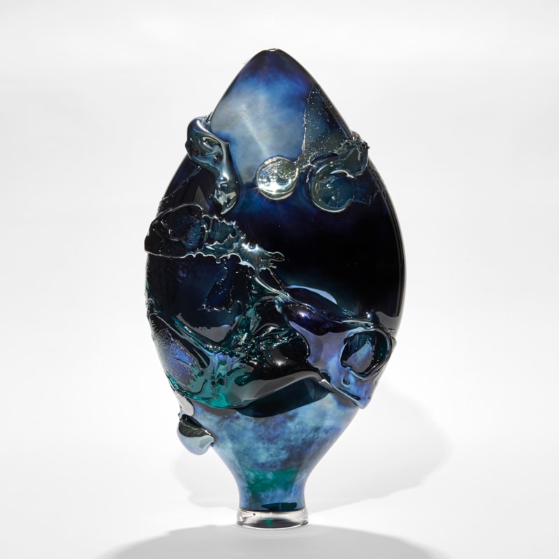 dark intense metallic blue teardrop shaped vase with organic trailing and swirling raised texture hand made from glass