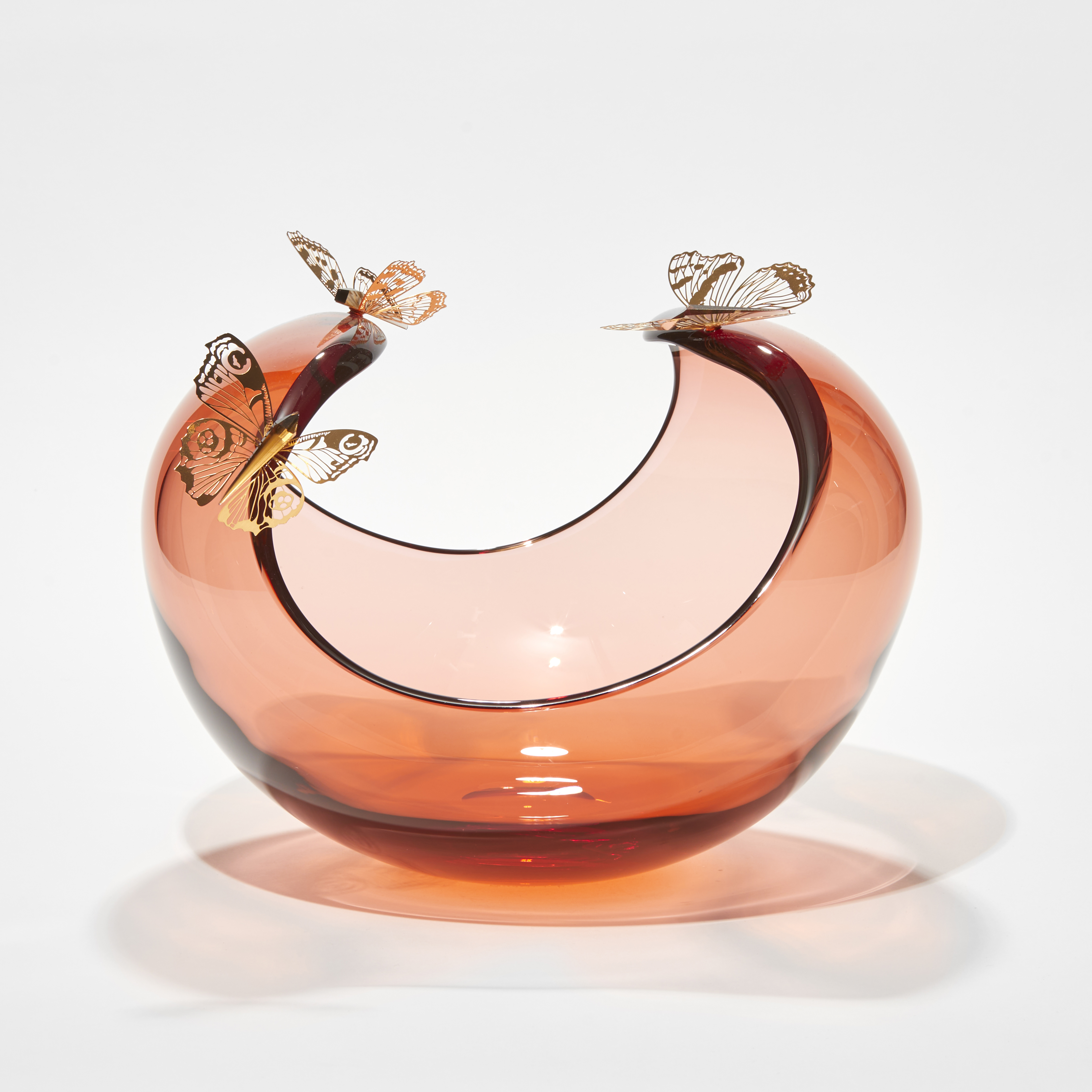 low round peach centrepiece with curved sweeping dropping rim with three gold butterflies perched on the edge hand made from glass steel and gold