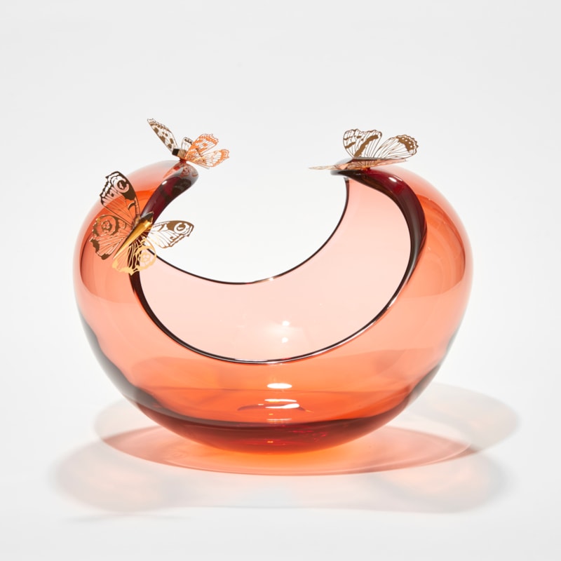 low round peach centrepiece with curved sweeping dropping rim with three gold butterflies perched on the edge hand made from glass steel and gold