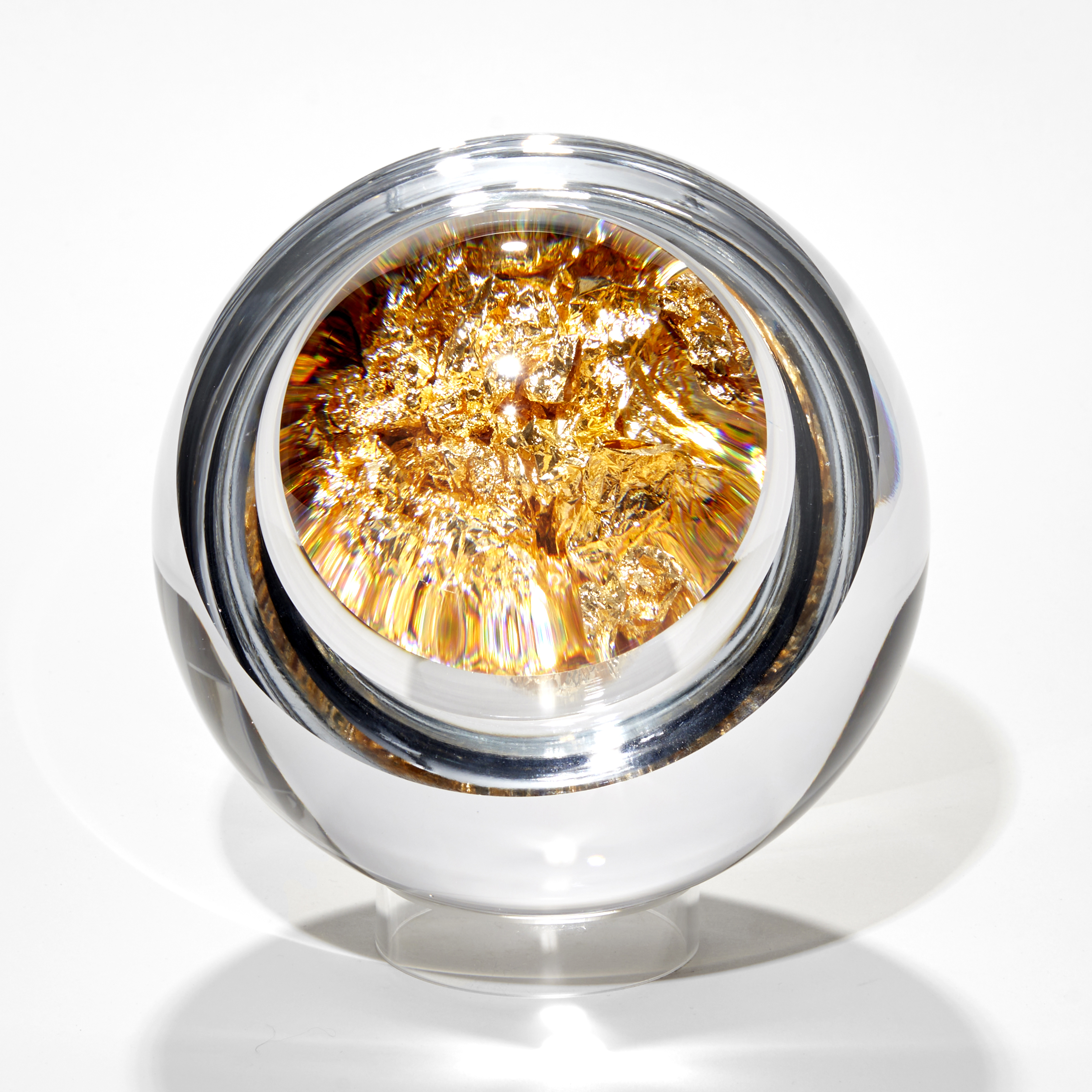 clear round orb with interior bubble filled with crushed gold leaf with front unremovable lens lid magnifying the contents hand made from glass