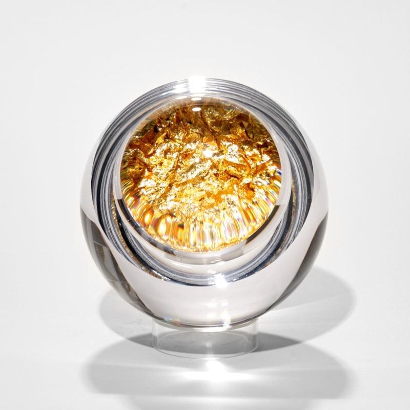clear round glass orb with hollow interior filled with crushed gold leaf hand made glass
