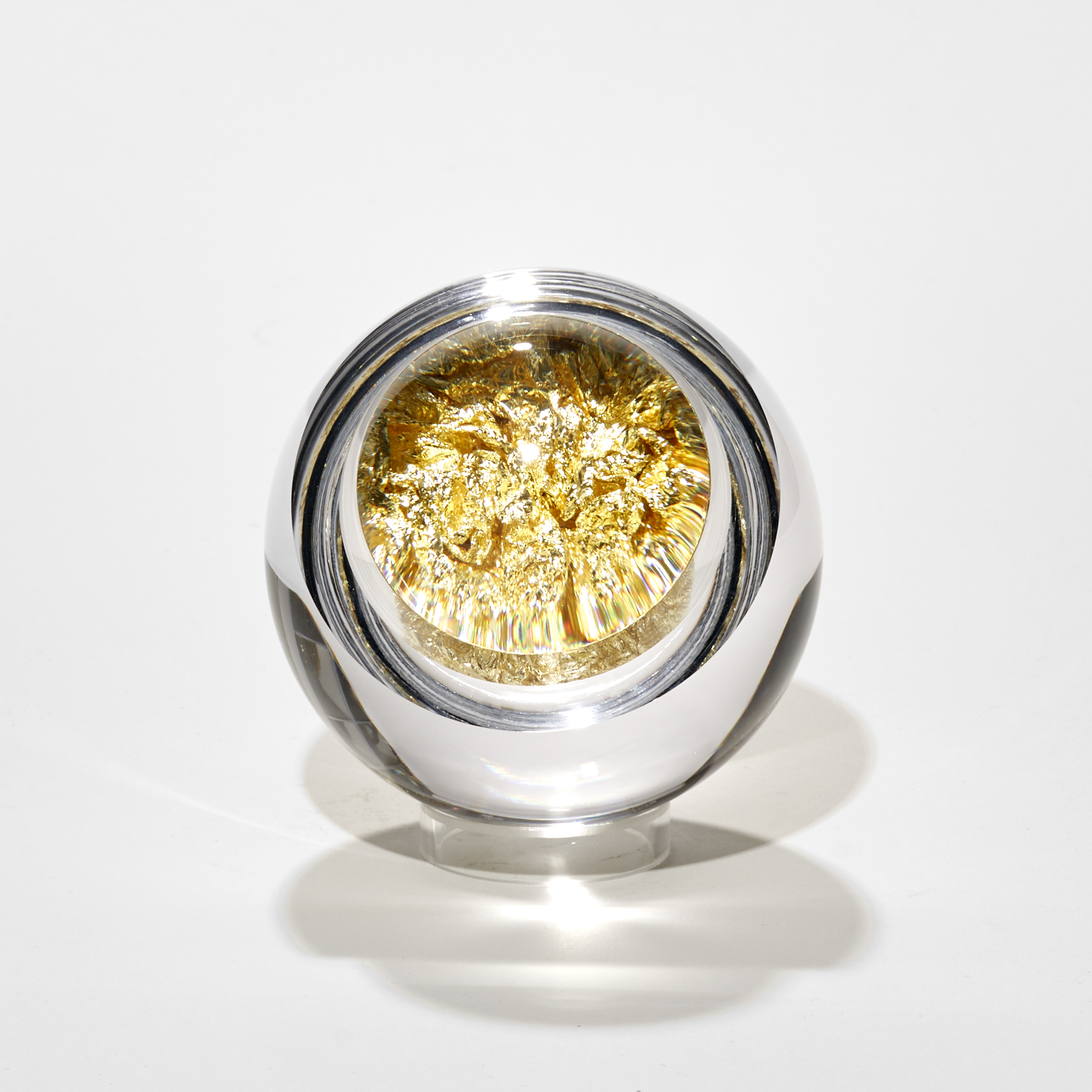 glass orb filled with crushed citron gold leaf hand made from blown and cut glass