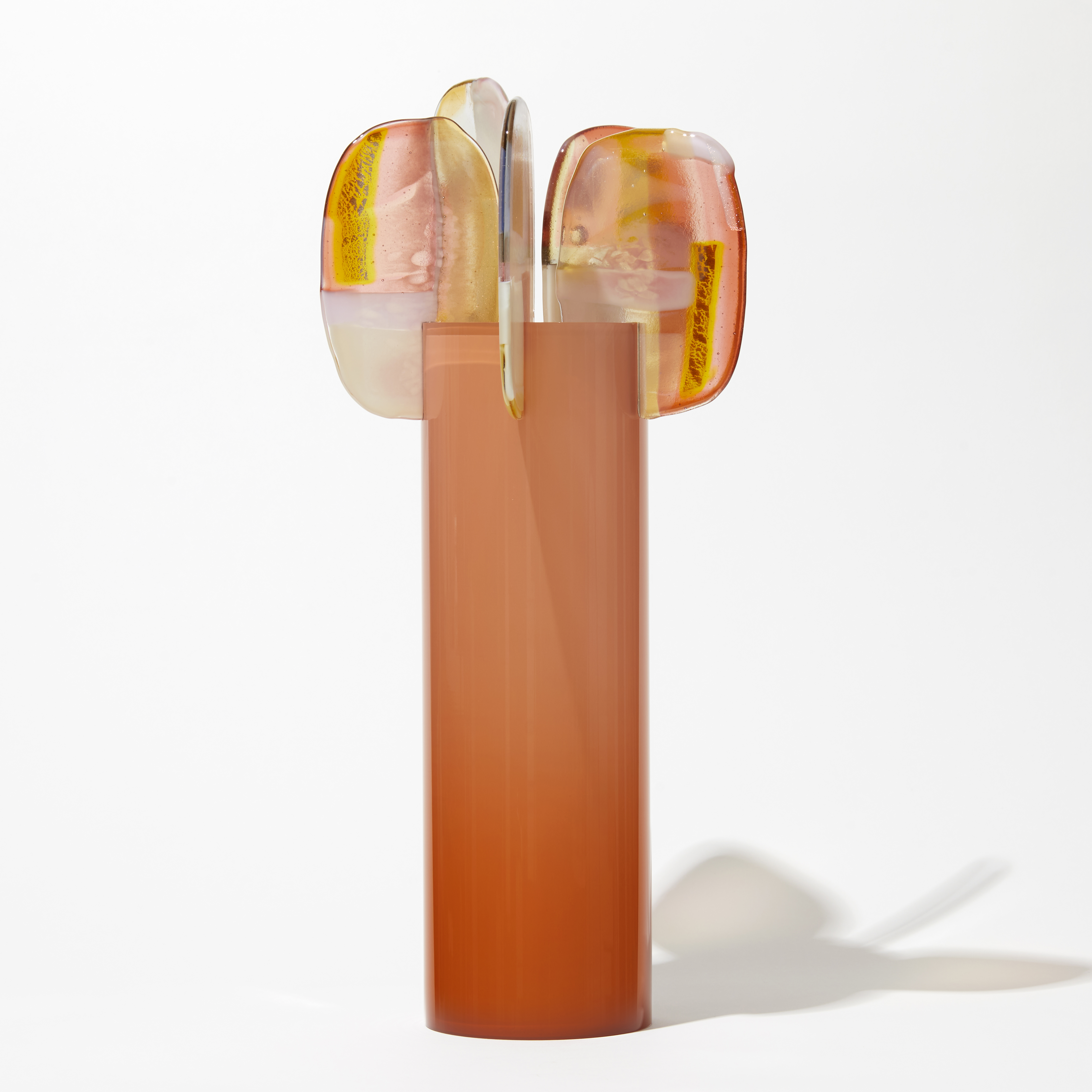 orange peach tall round glossy cylinder fading in intensity towards the top with five rounded lollipop like leaves with pink orange yellow and opal white abstract patterns perched at the top hand made from glass