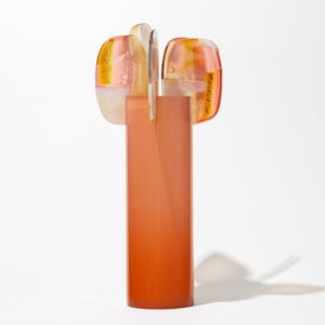 orange peach tall round glossy cylinder fading in intensity towards the top with five rounded lollipop like leaves with pink orange yellow and opal white abstract patterns perched at the top hand made from glass