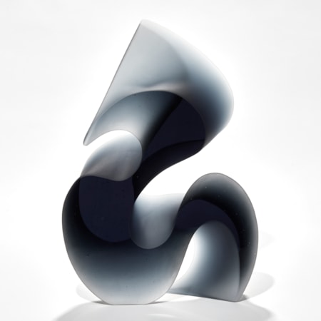 greyish blue tall curved and curling abstract shape made from cast glass with two flat polished sides and curved matt satin sides