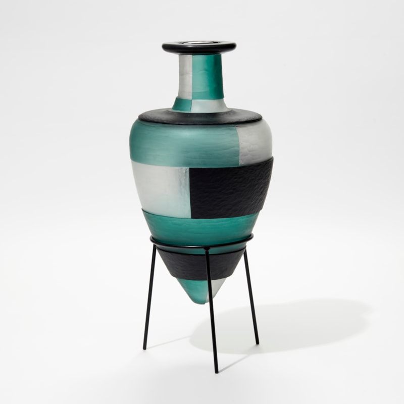 jade clear and dark forest green amphora glass bottles with textured surface and block pattern perched in a tripod black steel base