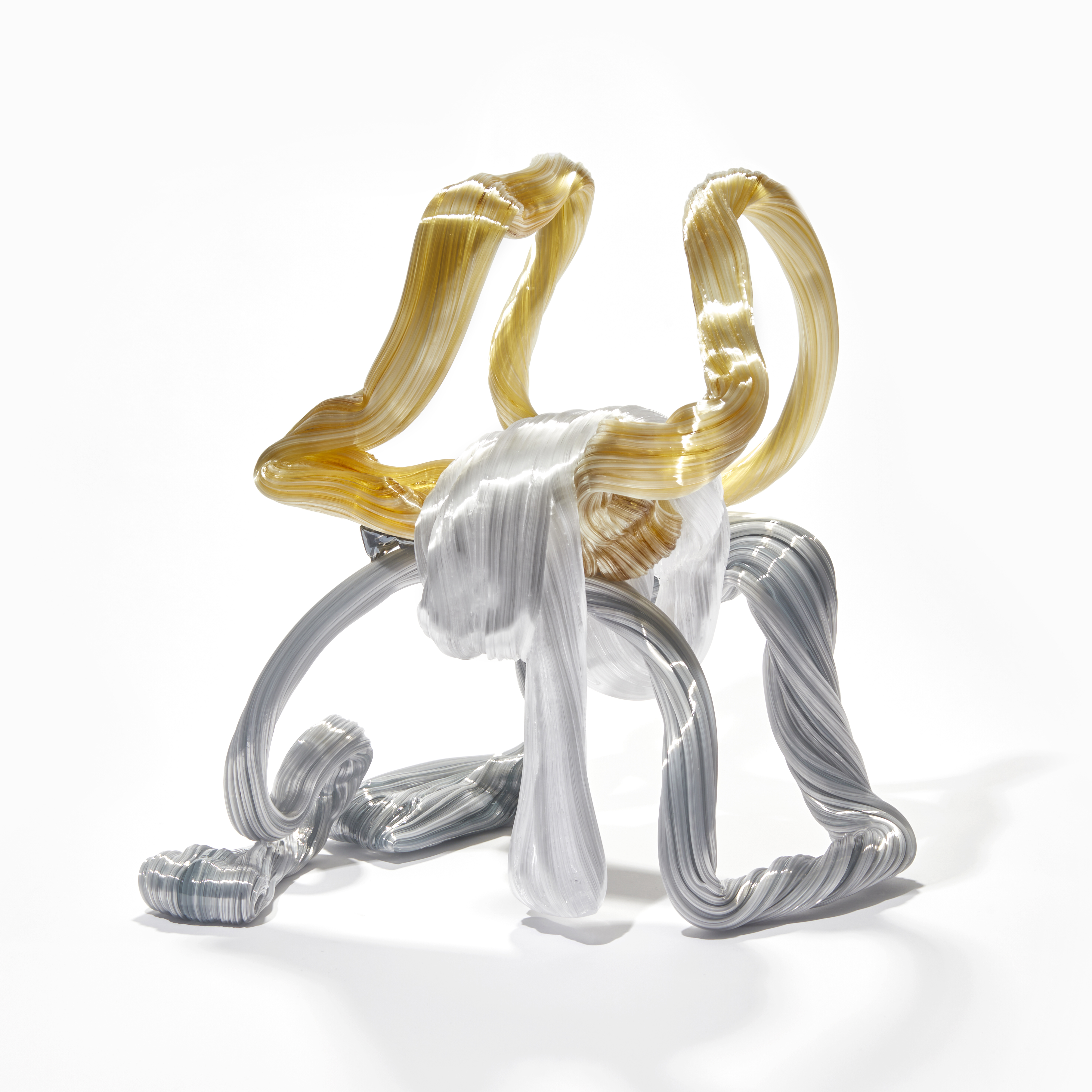 looped ridged candy canes in white amber and grey creating a standing form handmade from glass