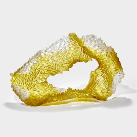 soft squat textured organic rough oval standing form in white and gold yellow with one side shiny the other textured with raised scales hand made from cast glass