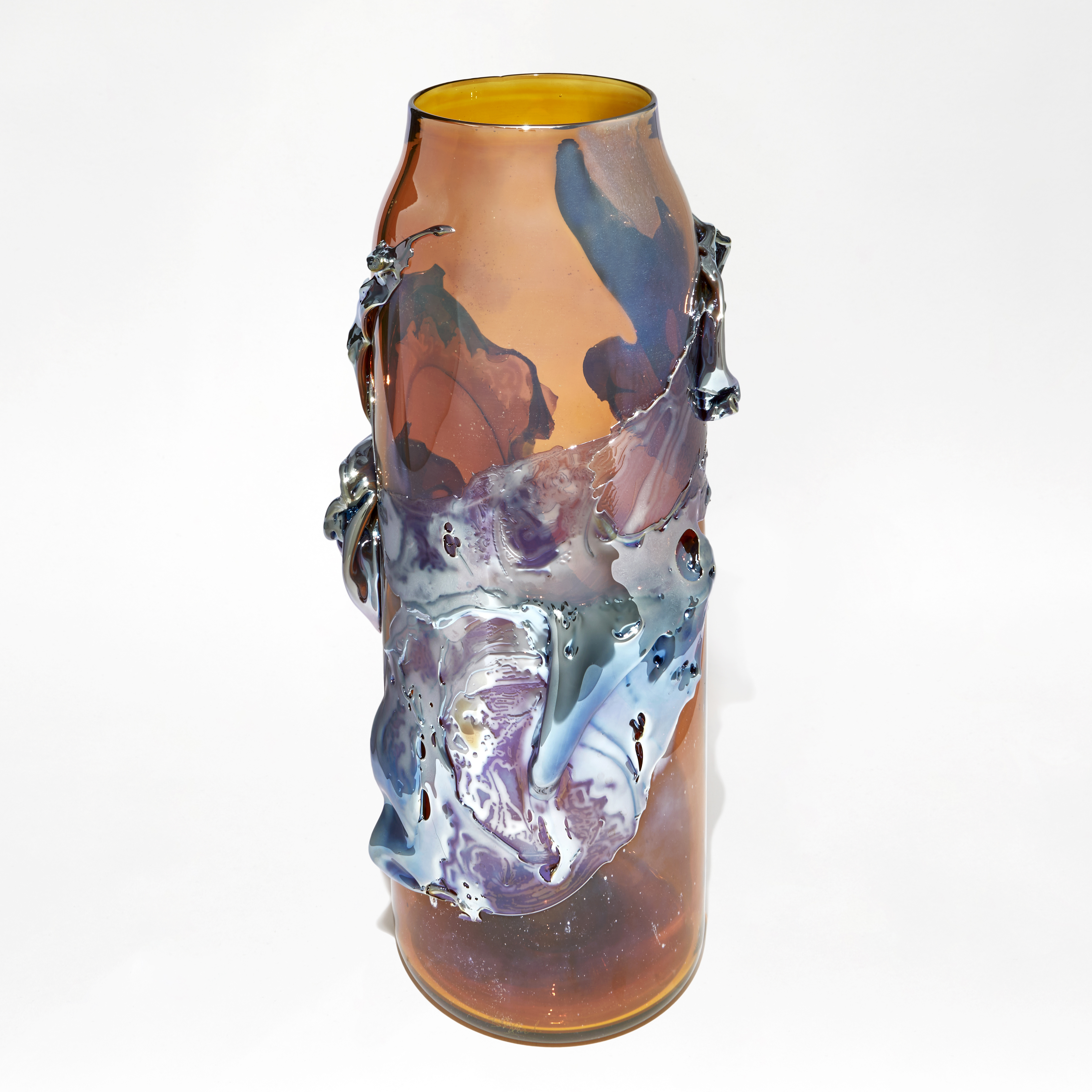 brilliant transparent amber cylindrical vase with tapering neck with roushed organic textural raised detail in metallic blue and lilac handmade from glass