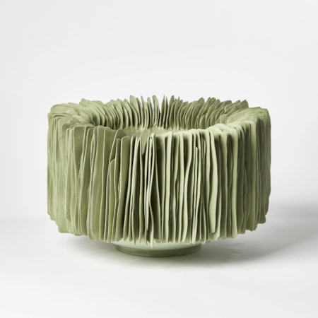 sage green round bowl with high sides covered in vertical ridged fins with a weathered look like tidal worn rocks hand made from porcelain