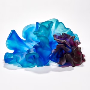 two coral interlocking forms one intense blue the other rich deep purple with the appearance of coral with smooth surfaces and frilled edges hand made from glass